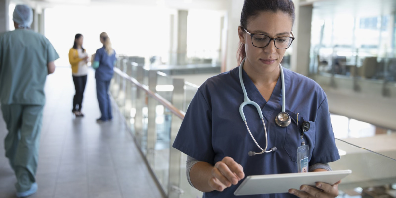 Nurse reviewing orders on a tablet